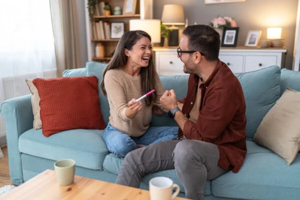 Happy young couple with pregnancy test